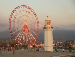white and red ferris wheel and white lighthouse thumbnail