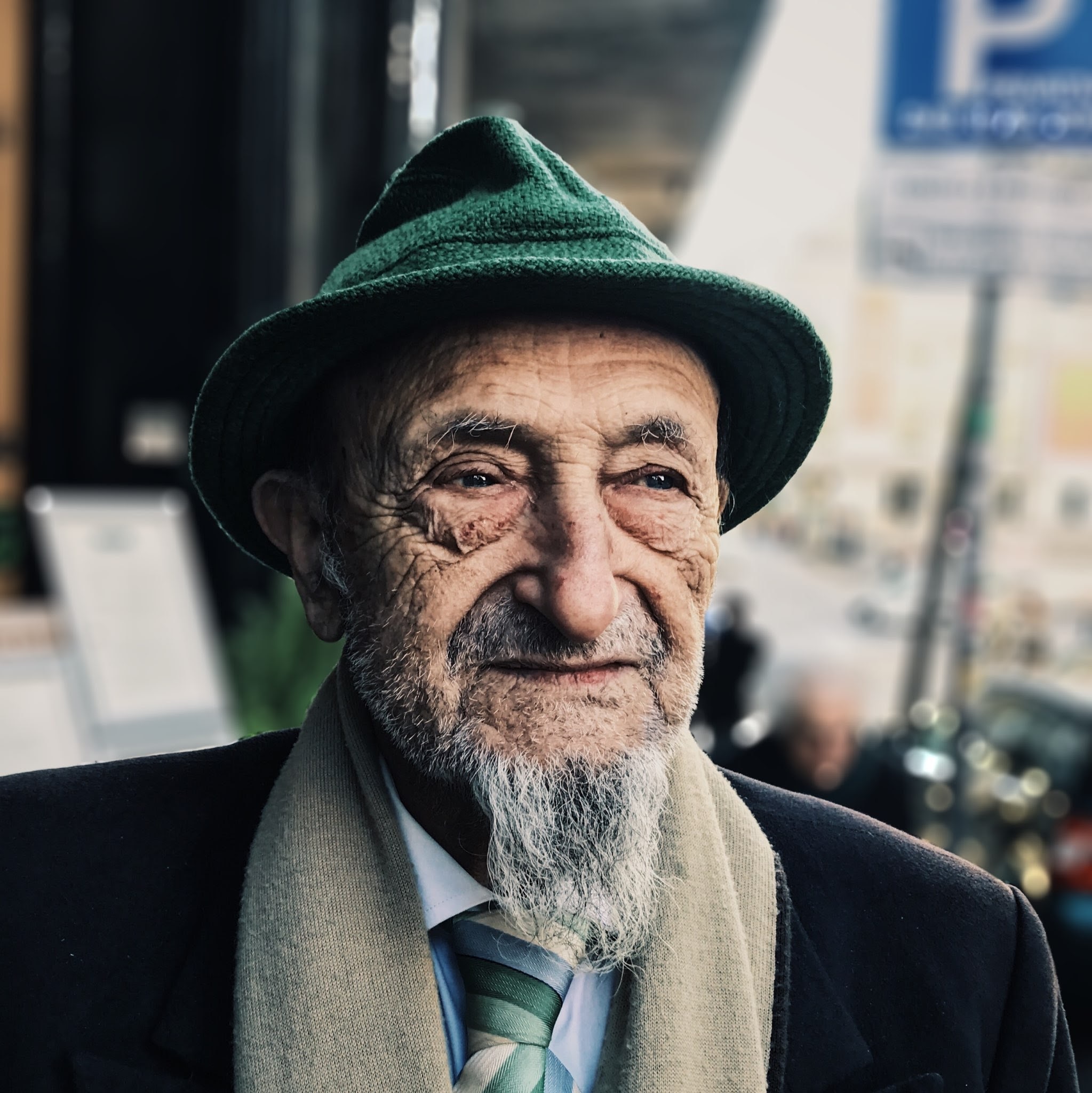 man wearing green cap and brown scarf