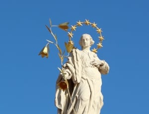 man holding branch statue thumbnail